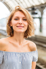 Close-up portrait of a blonde woman on train station