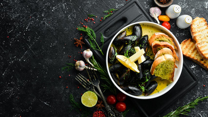 Boiled mussels with cheese sauce and garlic. Top view. Free space for text.