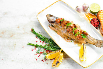 Baked sea bass with mushrooms in a creamy sauce. Top view. Free space for text.