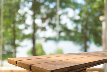 Fototapeta premium Wooden table on defocuced window with curtain background