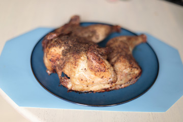 Dry rub spatchcock chicken resting on a plate.