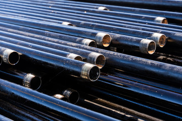 Pipe for Drilling rigs for oil and gas on background. Drilling of oil and gas wells. Drill pipe....