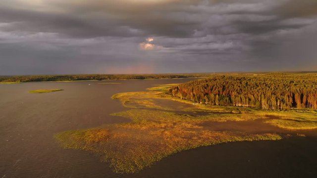 Aerial view of the storm clouds. Drone flight over large lake. Shot in Braslaw Lakes national park in Belarus. Summer season