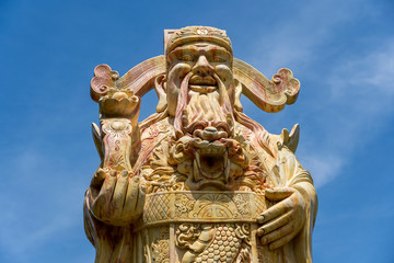 Face of an ancient Chinese warrior statue or god Chinese in a Buddhist temple in the city of Danang, Vietnam