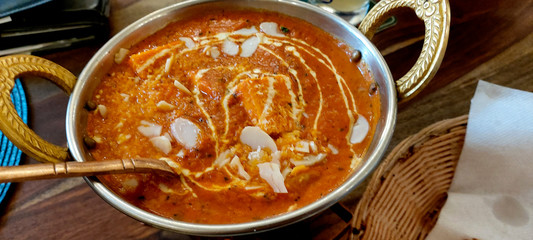 Indian food including curries, spice sauce and naan bread.