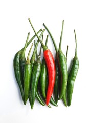 Green and a red chilli on white background