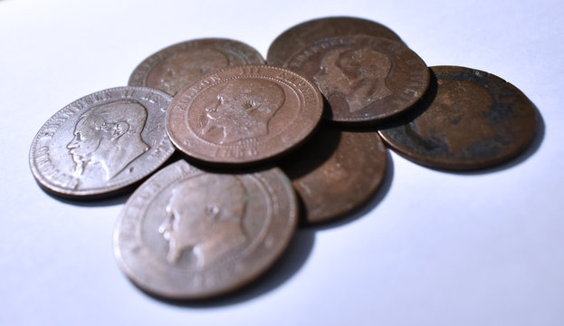 View of a pile of european coins from the eighteenth century with white background