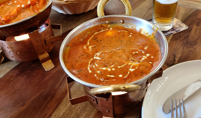 Indian food including curries, spice sauce and naan bread.