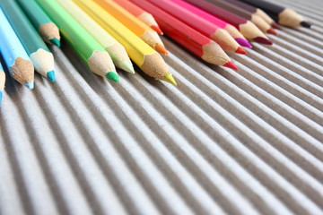 Close-up on color pencils on brown corrugated cardboard
