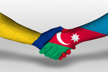 Handshake between azerbaijan and columbia flags painted on hands, illustration with clipping path.