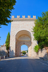 Fototapeta na wymiar Famous old town of Assisi with city gate in Umbria, Italy.