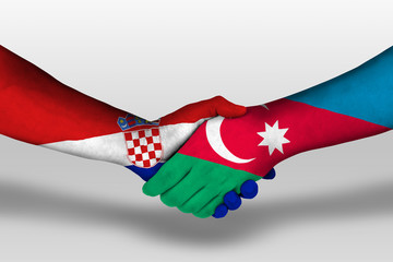 Handshake between azerbaijan and croatia flags painted on hands, illustration with clipping path.