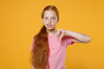 Puzzled confused little ginger redhead kid girl 12-13 years old in pink casual t-shirt posing...