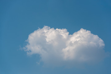 Beautiful heart shpae clouds floating on the blue sky with copy space.