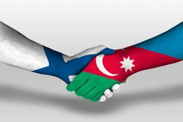 Handshake between azerbaijan and finland flags painted on hands, illustration with clipping path.