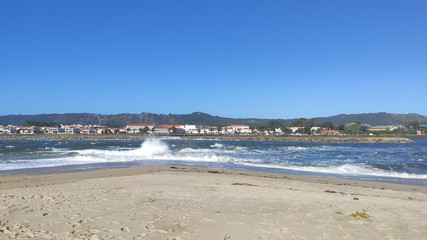 Waves of water of the river and the sea meet each other during high tide and low tide. Whirlpools of the Cavado River in Esposende, Portugal.