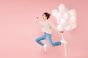 Full length portrait side view of happy young woman in casual sweater isolated on pastel pink...