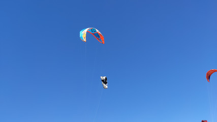 Ofir / Portugal - August 22, 2020: People practicing kitesurf. Kitesurfers on the mouth of the Cavado River in Esposende. Esposende it's renowned by kite-surfers as one of the best places to kitesurf.