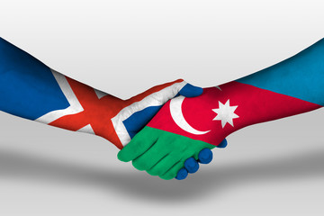 Handshake between azerbaijan and iceland flags painted on hands, illustration with clipping path.