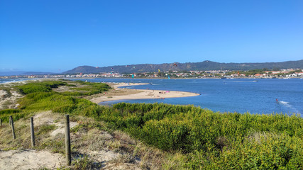 People practicing kitesurf. Kitesurfers on the mouth of the Cavado River in Esposende, Portugal....