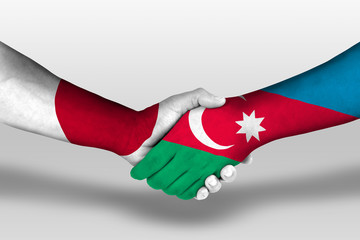 Handshake between azerbaijan and japan flags painted on hands, illustration with clipping path.