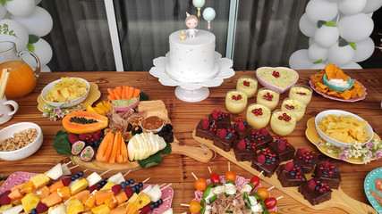 First Anniversary Party. Balloons, food and cake for children's birthday. The first birthday of the baby. Modern Vintage Decor for children's birthday. Birthday party concept.