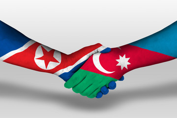 Handshake between azerbaijan and north korea flags painted on hands, illustration with clipping path.