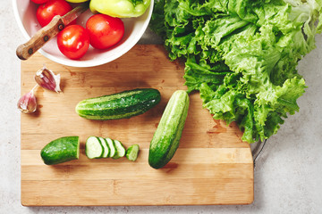 Fresh vegetables on a cutting board, salad ingredients.