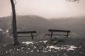 Two empty benches in winter