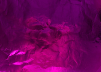 Crumpled textured foil with color highlighting. Textured colour paper. Purple colour.