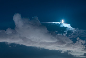 Naklejka na ściany i meble Scenic night image of the moon just above the clouds