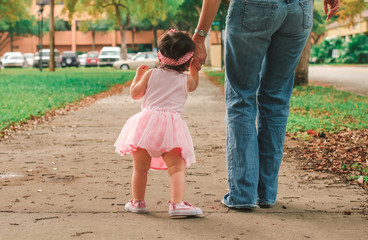 baby learning t walk with mammy and daddy 

