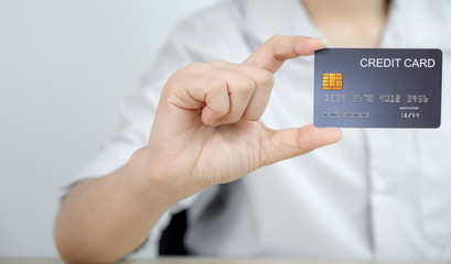 Businessman hand holding credit card to online shopping from home, payment e-commerce, internet banking, spending money for next holidays