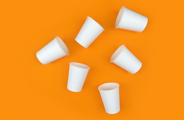 White paper cups on orange backdrop. Ecology. Zero waste, recycling concept. Mock up template. Flat lay view.