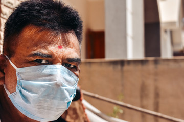 Portrait of an Indian man wearing medical mask during the coronavirus pandemic