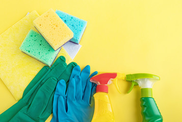 Gloves, napkins, sponges, detergents on a yellow background. Set for cleaning various surfaces in the kitchen, bathroom and other areas cleaning concept. Top view. flat lay