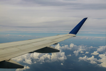 Obraz premium Aerial view of cloud and sky with airplane wing from window