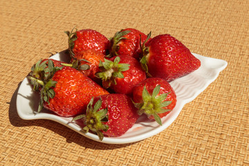 Ripe sweet strawberry in the bowl. Concept of a vegan breakfast.