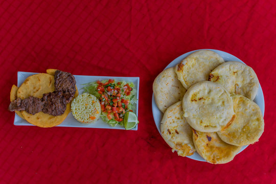 typical Salvadoran dish, roast beef, rice, chirmol and pupusas