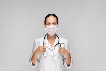 Portrait of an attractive young female doctor in white coat.