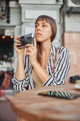 Beautiful female photographer is waiting for lovely moment