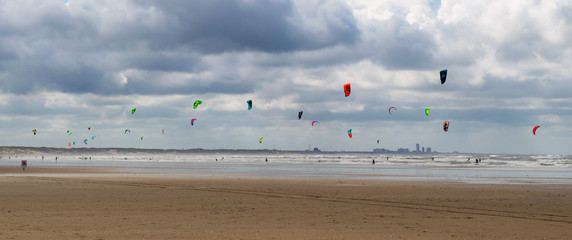 Kite surfers enjoying the wind and waves of the little sea town Ijmuiden aan zee