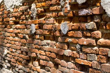Dilapidated with potholes old brick wall of the building, made of red brick, close up. Background...