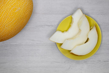 Yellow melon.Yellow melon on a background of bleached wood.