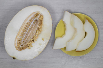 Yellow melon.Yellow melon on a background of bleached wood.