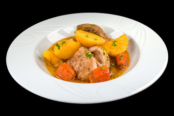Delicious  roasted pork with potatoes and carrots in a plate