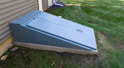 Storm cellar doors closed on side of house