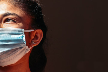 Portrait of an Indian female wearing medical mask to prevent herself from the Corona Virus Pandemic	