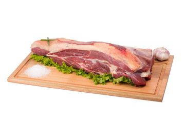 Fototapeta premium fresh and raw beef meat on cutting board on white background
