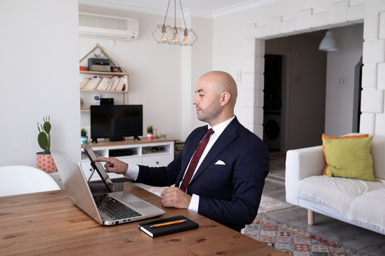 young man working remotely with leptop at his home. Distance Learning.